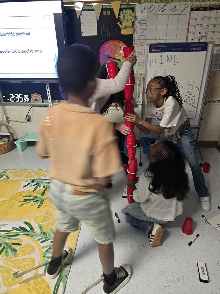Kids building cup towers