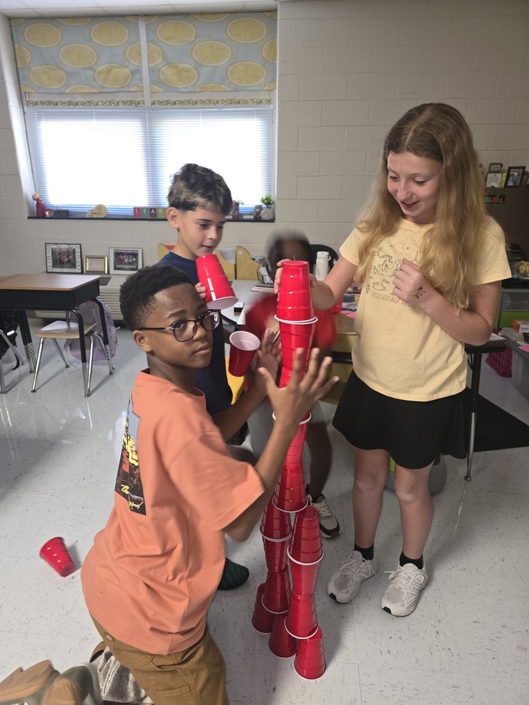Kids building cup towers