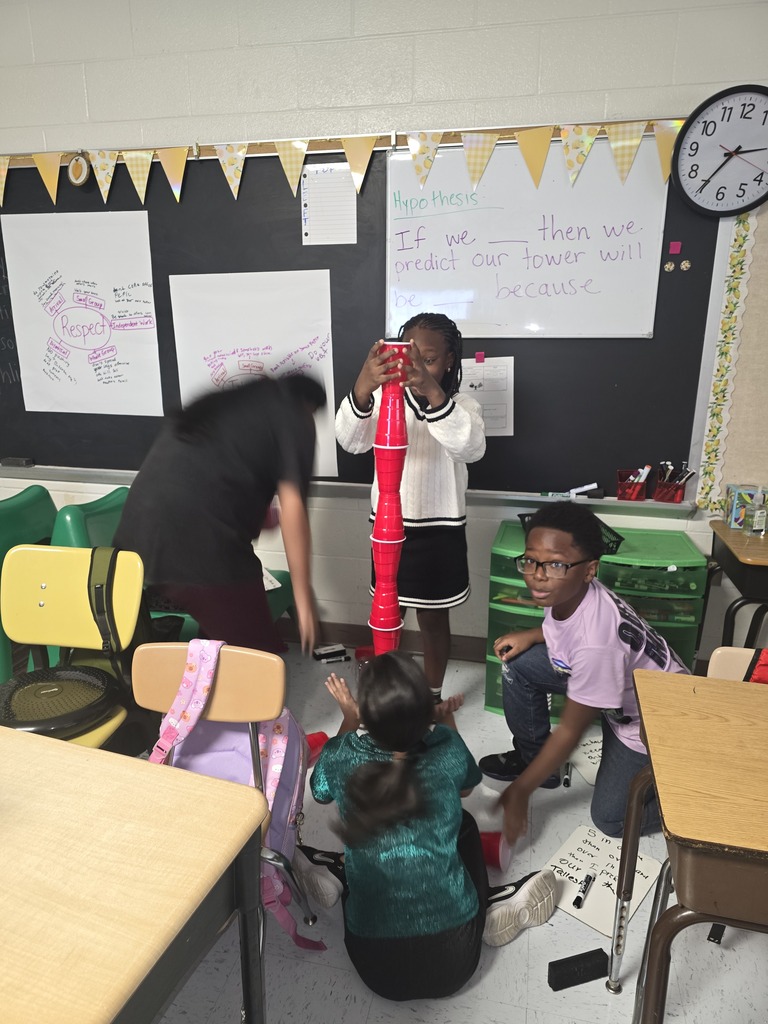 Kids building cup towers