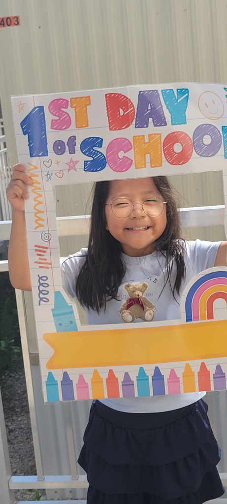 4th grade student holding first day of school sign