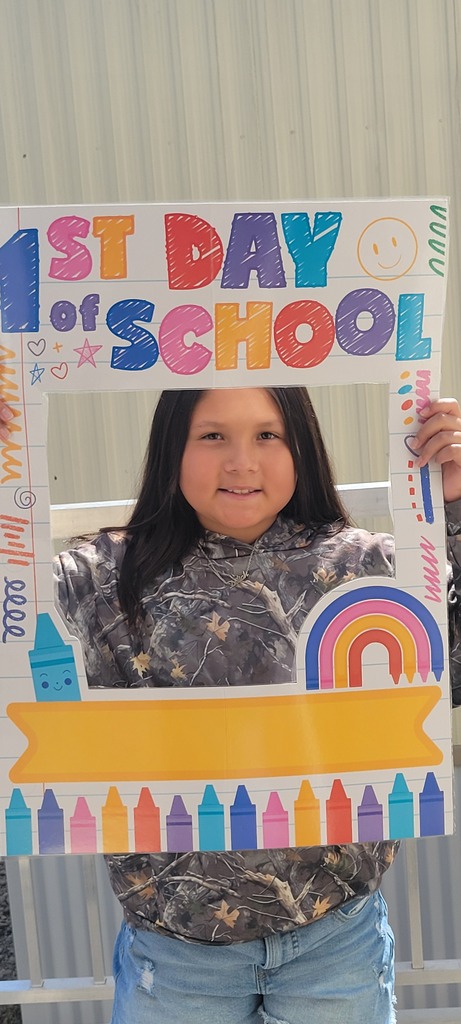 4th grade student holding first day of school sign