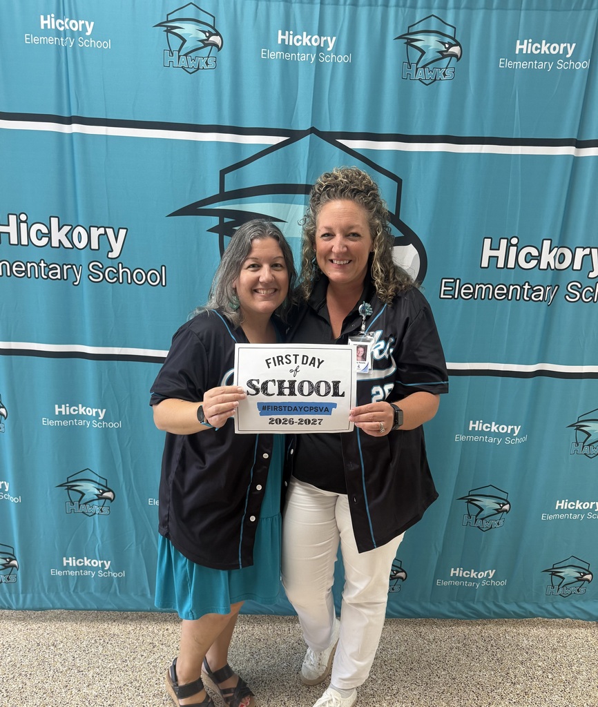 admin holding first day of school sign
