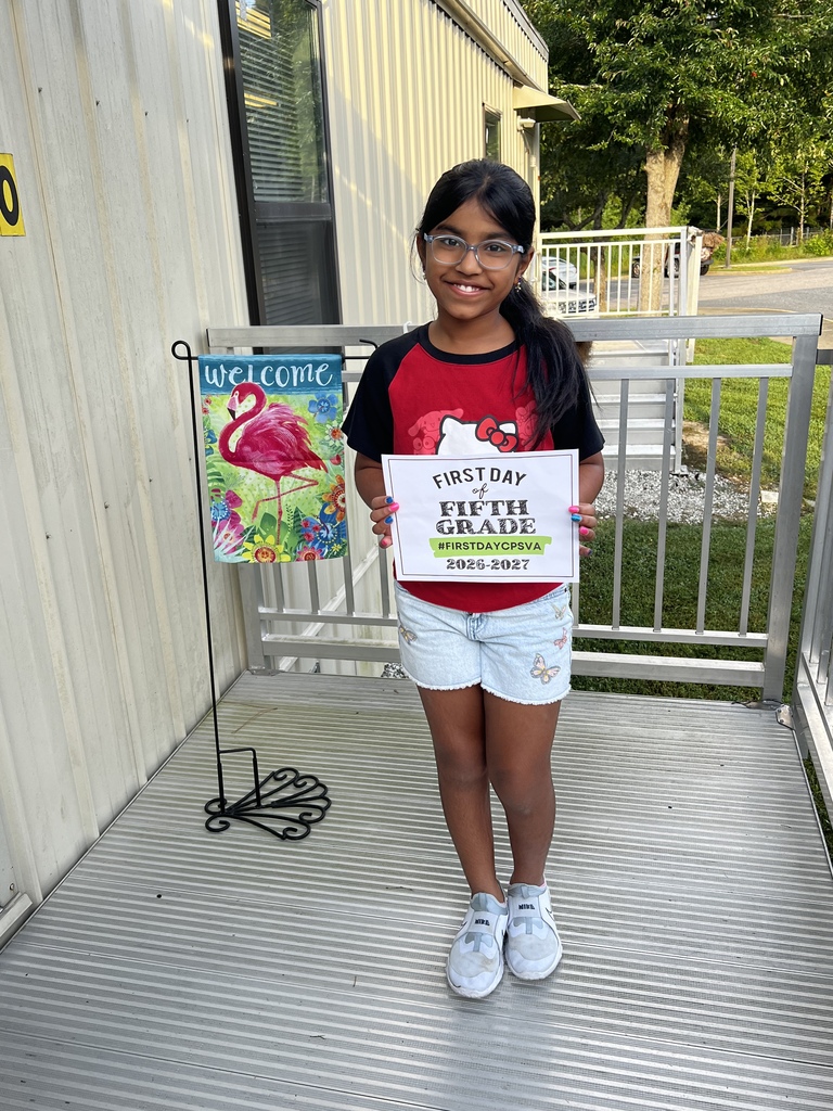 fifth grade student holding first day of school sign 