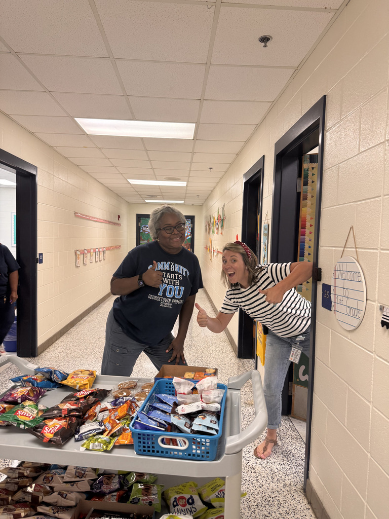 teacher and assistant principal give a thumbs up pose