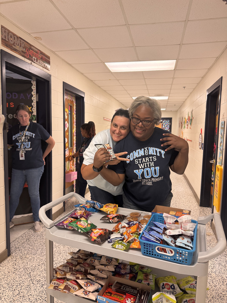 staff hug in front of snack cart