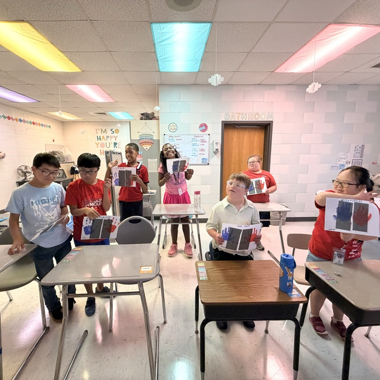 students proudly smiling in their classroom
