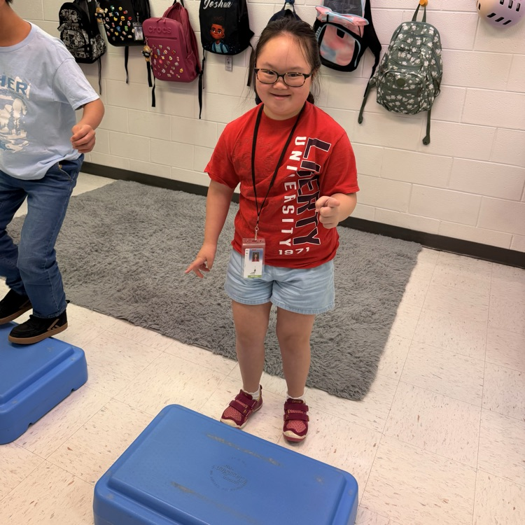 smiling students stepping on boxes