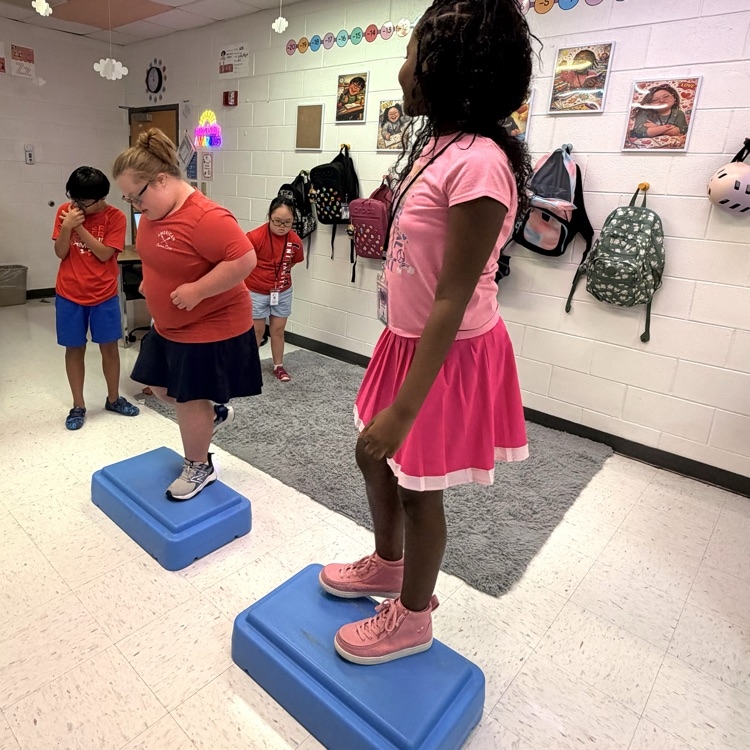 smiling student stepping on boxes