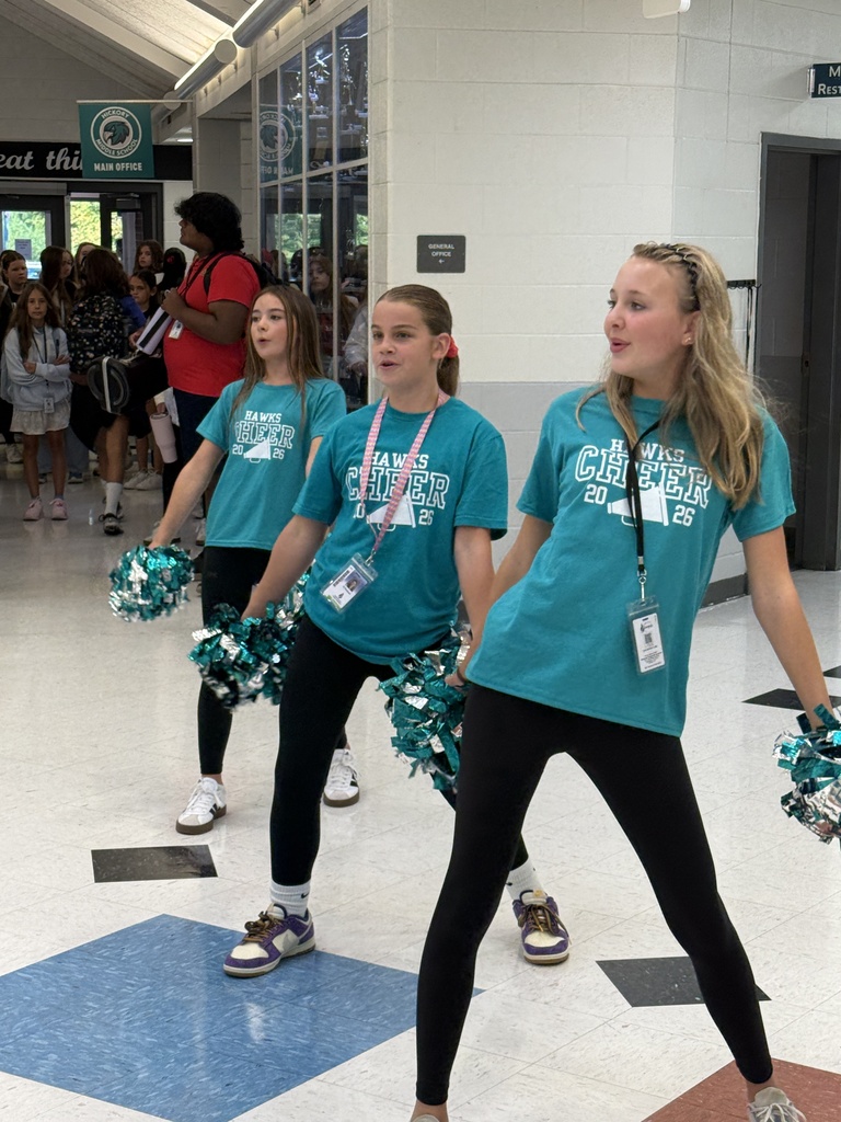 cheerleaders cheering at the front foyer of the school