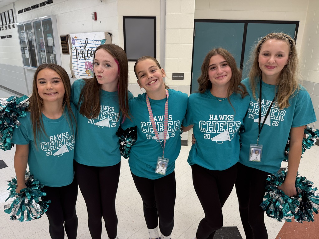 cheerleaders smiling and welcoming students in the morning