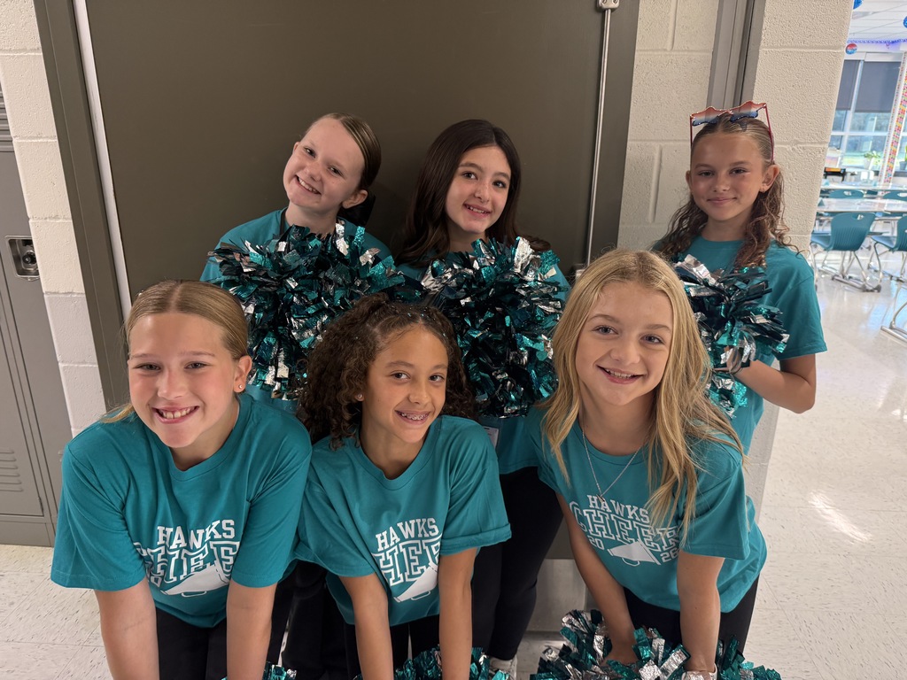 cheerleaders smiling and welcoming students in the morning