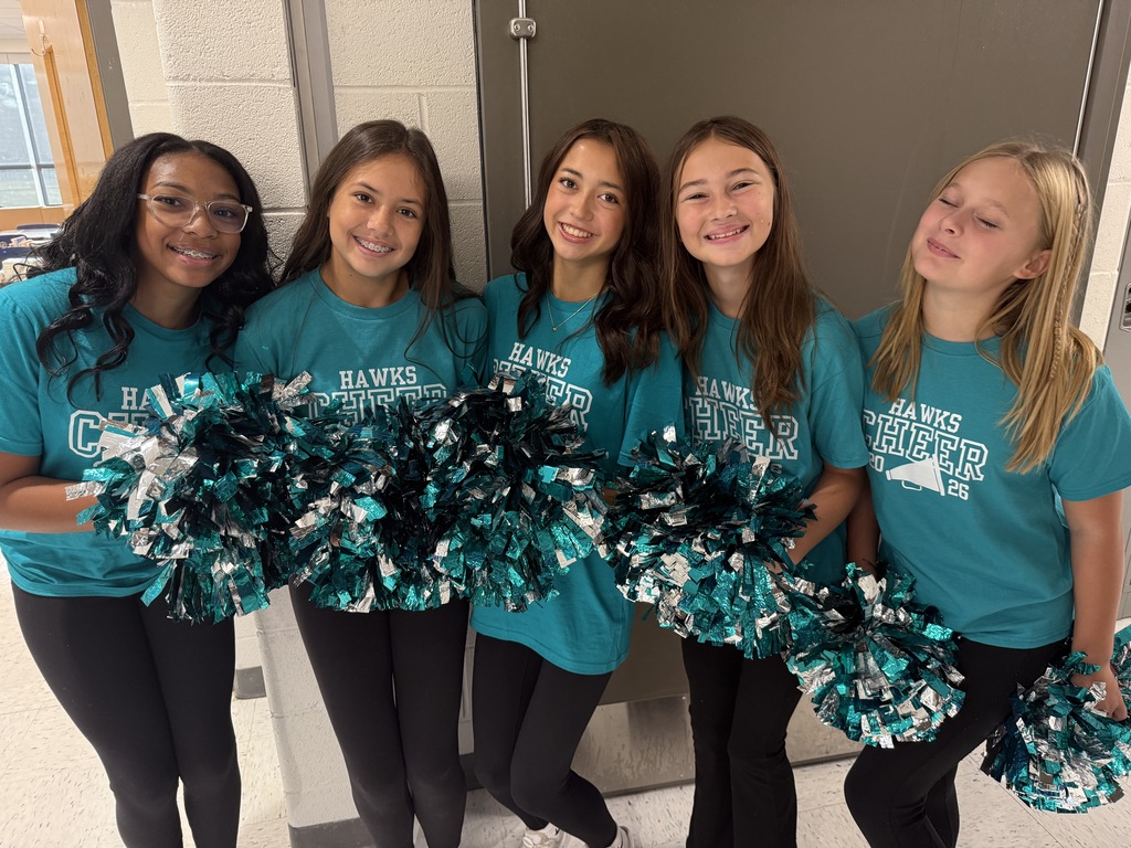cheerleaders smiling and welcoming students in the morning
