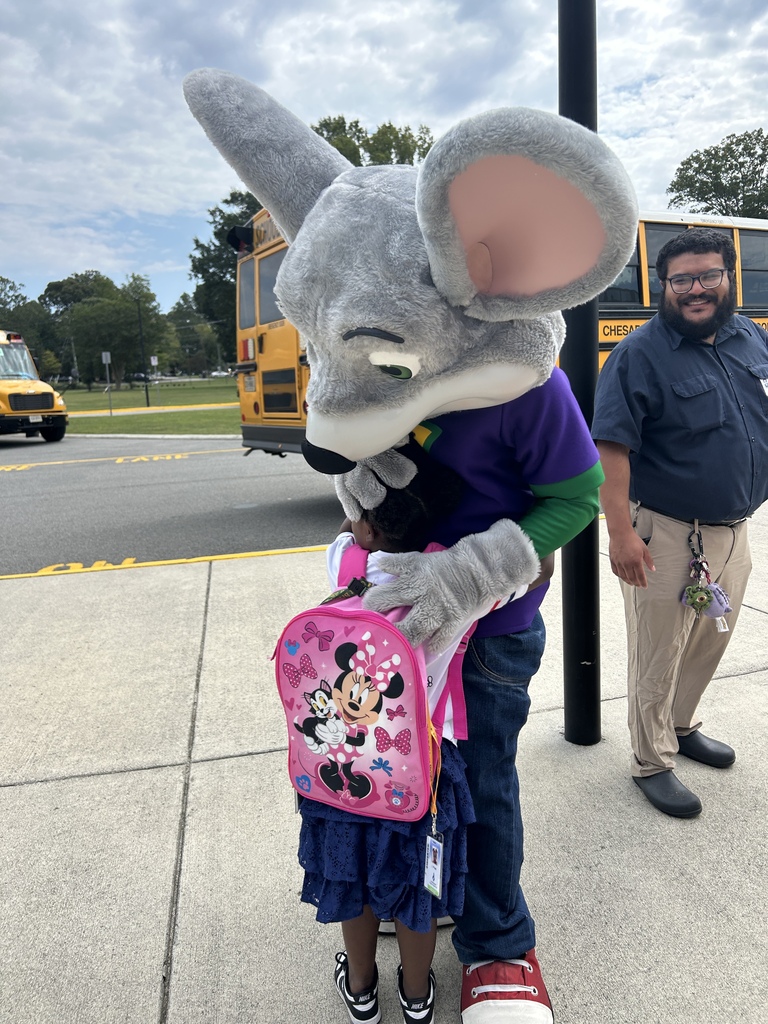 Student hugging Chuck E. Cheese before leaving for dismissal