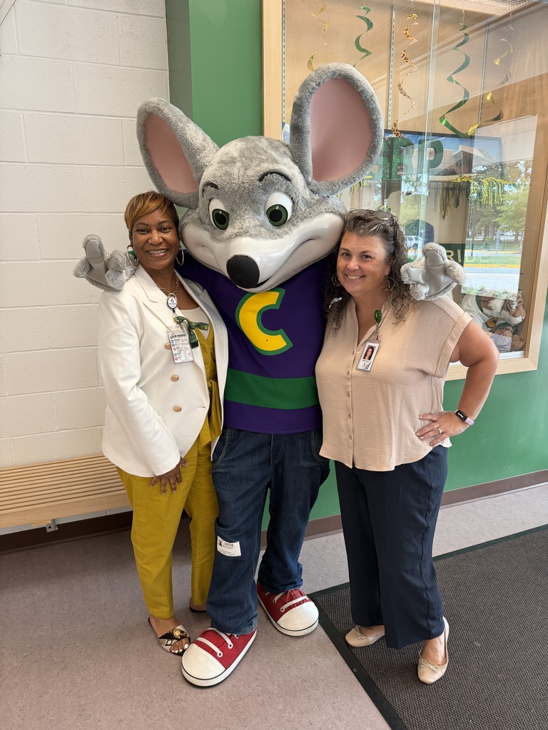 Mrs. Taylor and Ms. Baker-Hardison posing next to Chuck E. Cheese