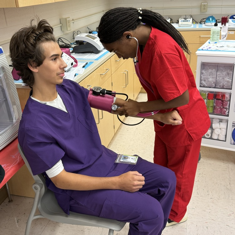 med lab student practicing blood pressure 