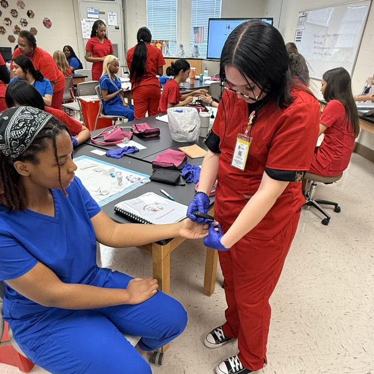 med lab student practicing blood pressure 