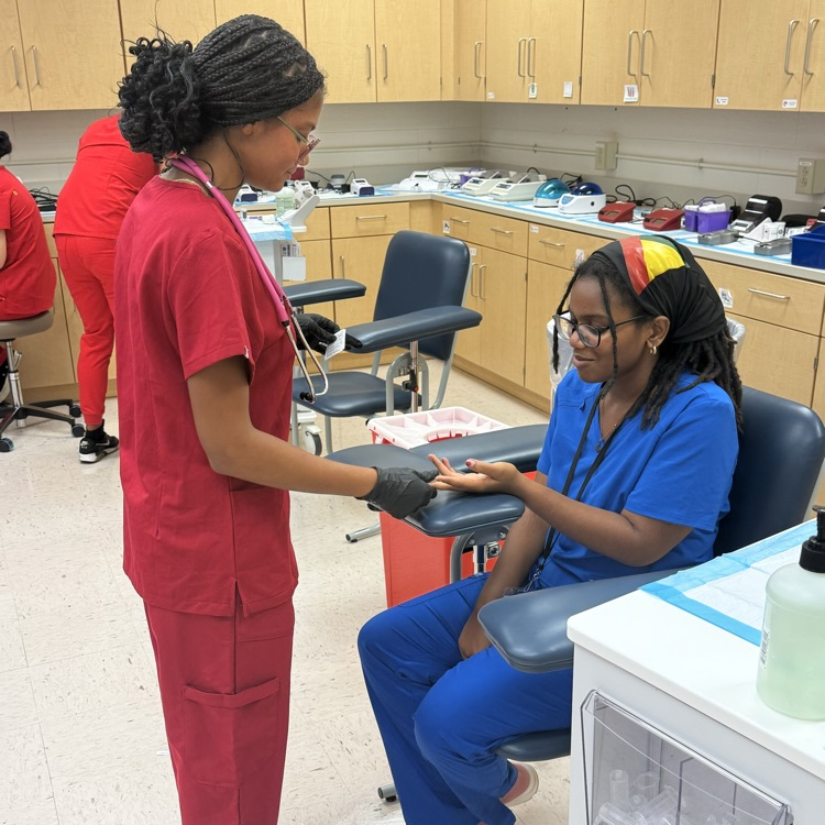 med lab student practicing blood pressure 