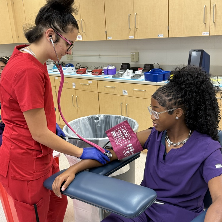 med lab student practicing blood pressure 