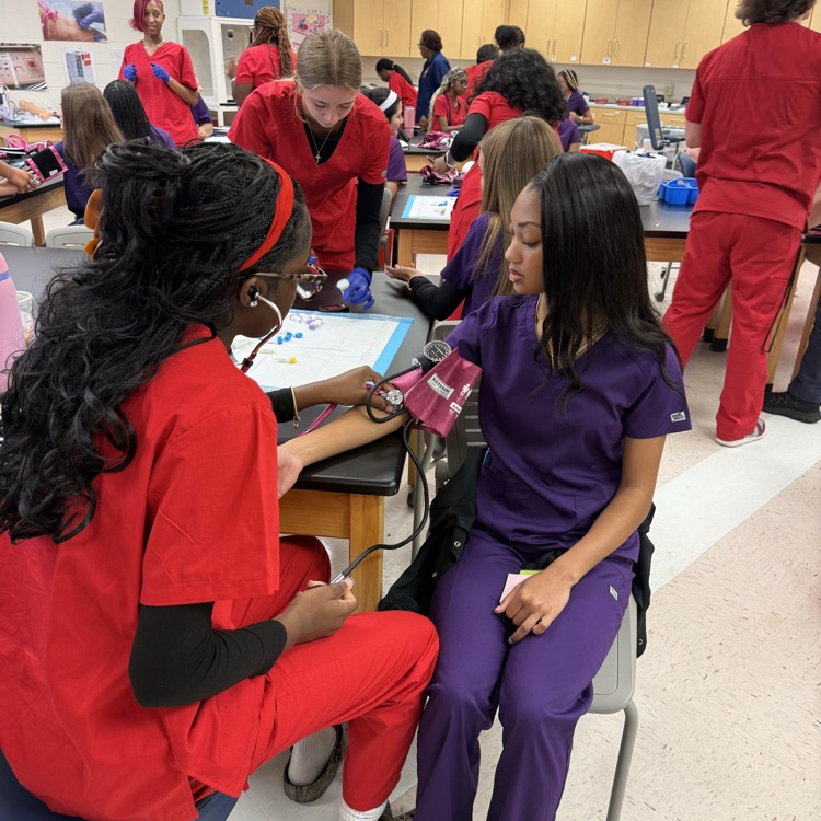 med lab student practicing blood pressure 