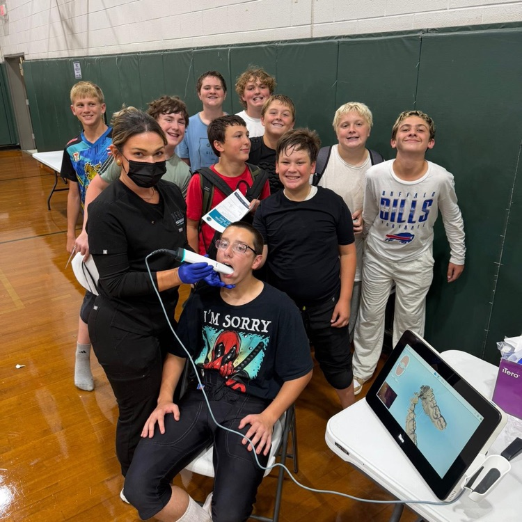 football players being fitted for personalized mouthguards