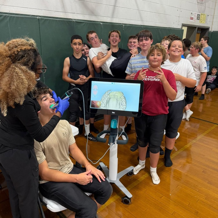 football players being fitted for personalized mouthguards