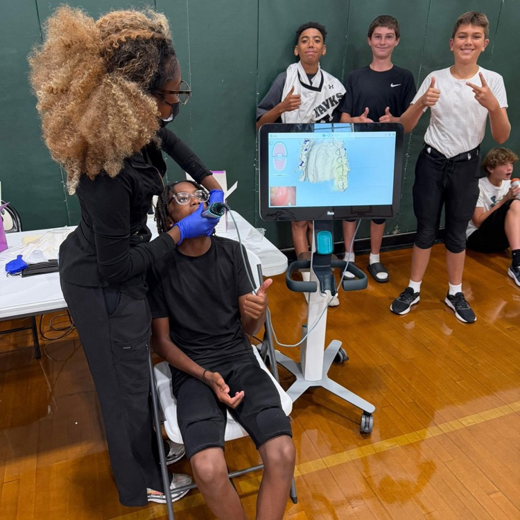 football players being fitted for personalized mouthguards
