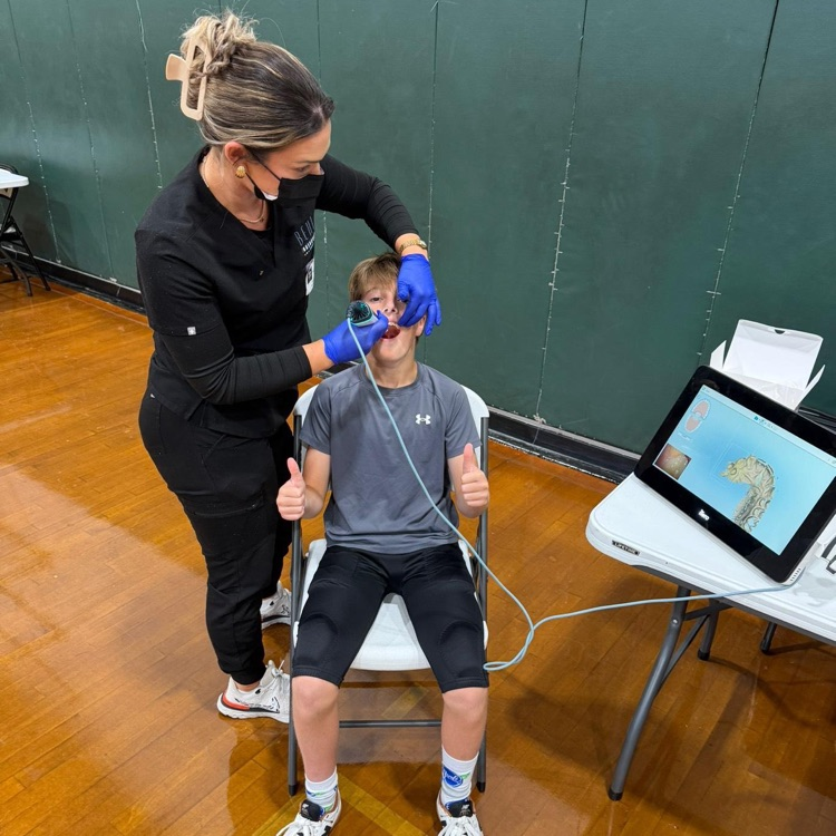 football players being fitted for personalized mouthguards