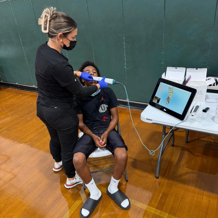 football players being fitted for personalized mouthguards