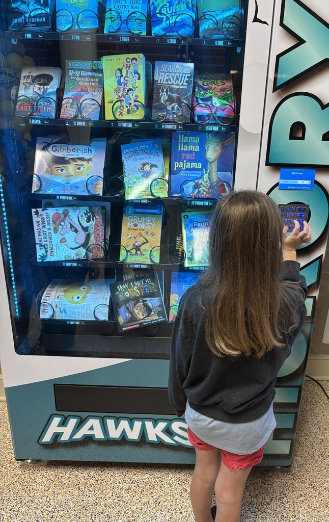 student picking a book from the book vending machine