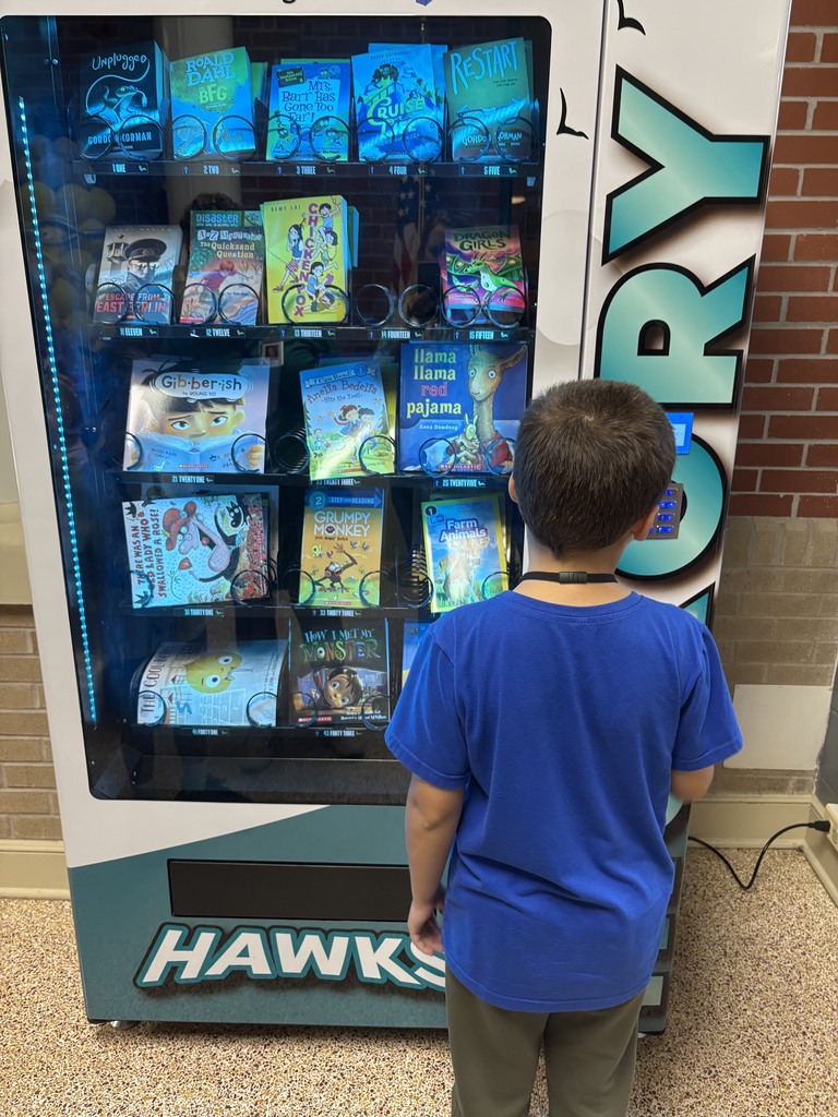 student picking a book from the book vending machine
