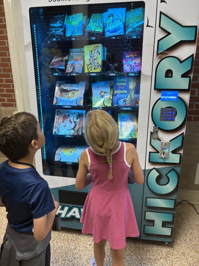students picking books from book vending machine