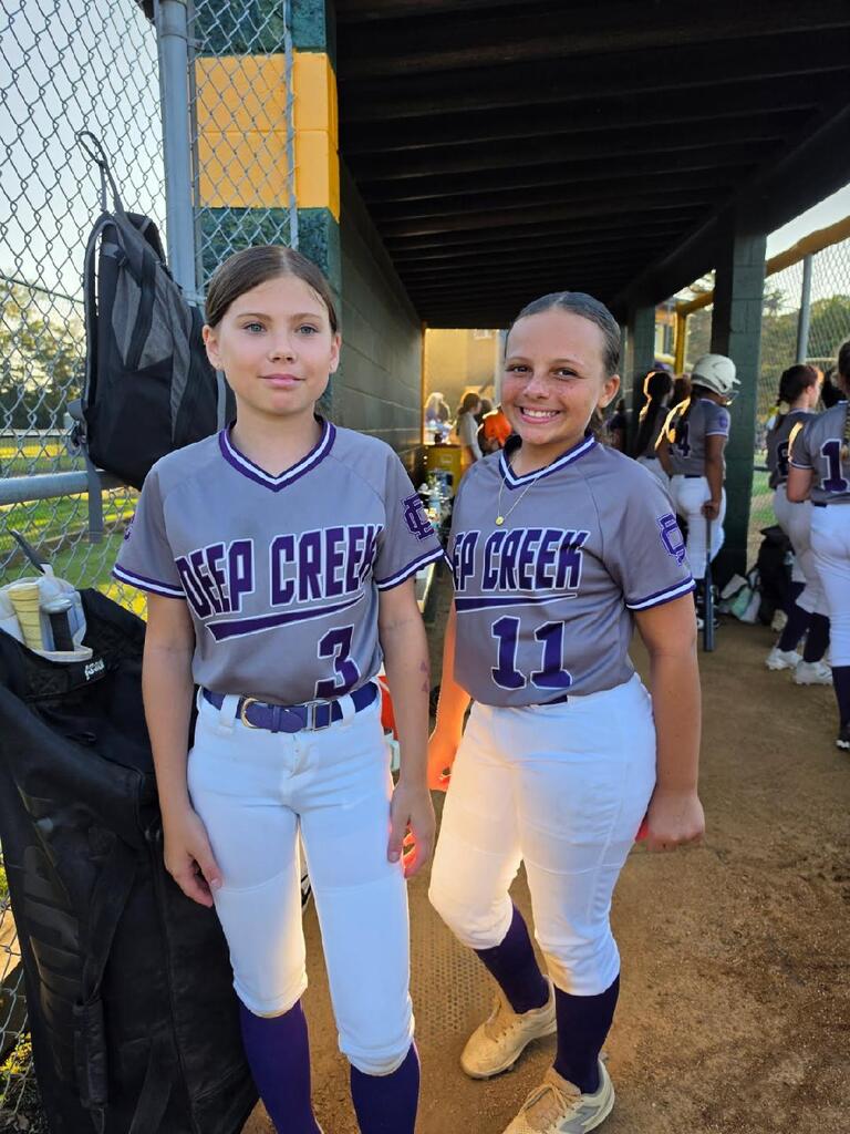 Two girls posing and playing softball for DCMS