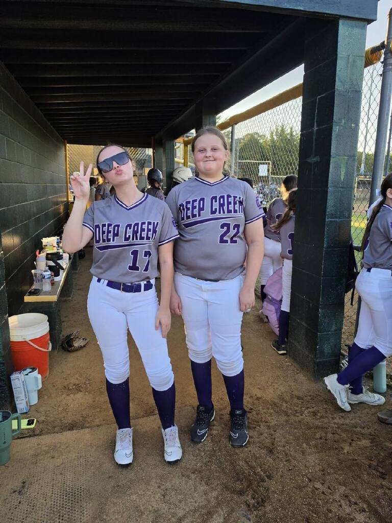 Two girls posing and playing softball for DCMS
