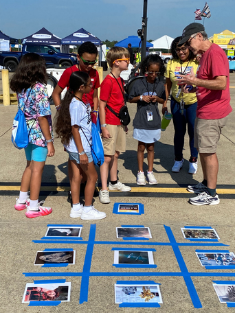 students playing game at air show