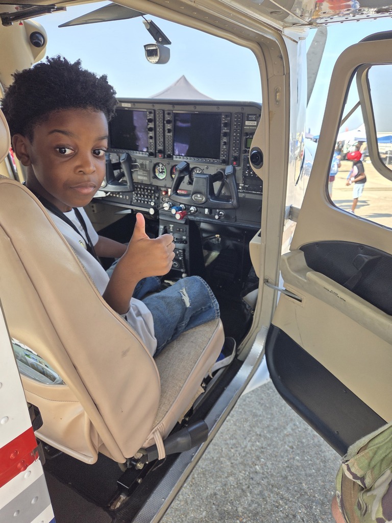 student in cockpit of airplane