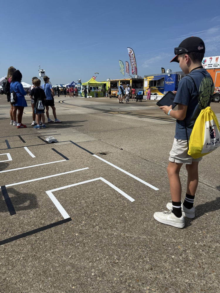 students coding vehicles through a maze