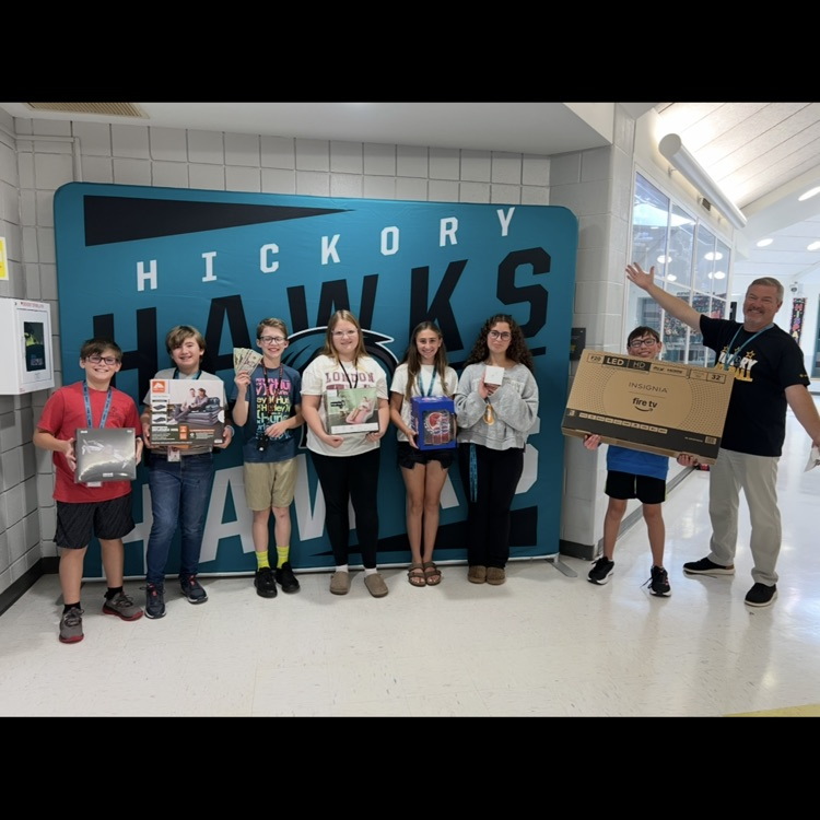 students excitedly displaying their prizes with our principal