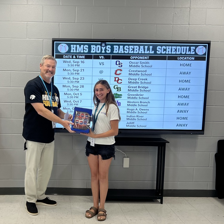 student standing proudly with her prize