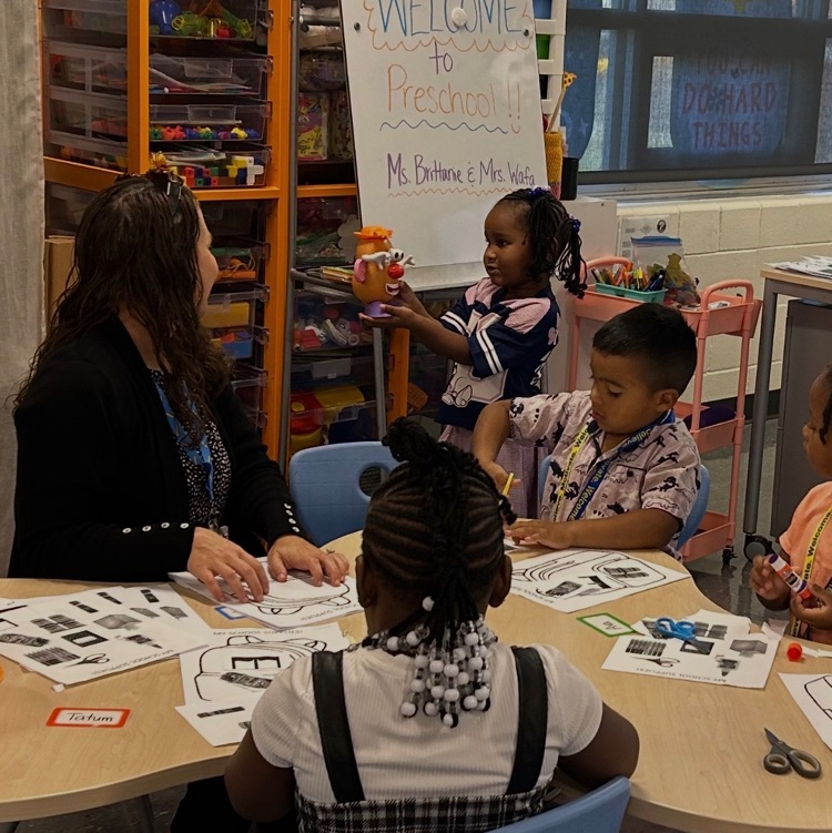 Ms. Brittanie and her students at the small group table.