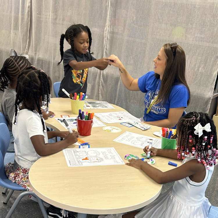 Ms. Brittanie working with students at the small group table.