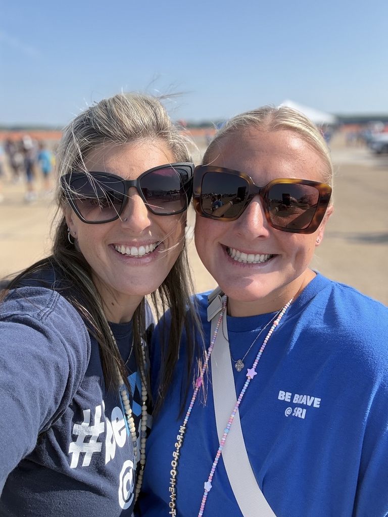Two teachers smiling together at the Oceana Air Show.