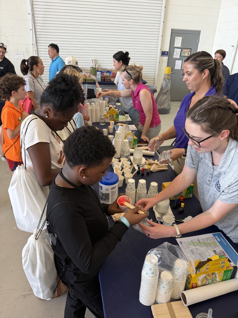 Students making smile at one of the STEM stations at the Oceana Air Show.
