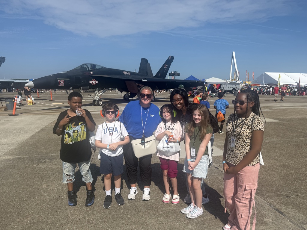 Mrs. Rochevot and students in front of a navy plane at the airshow.   