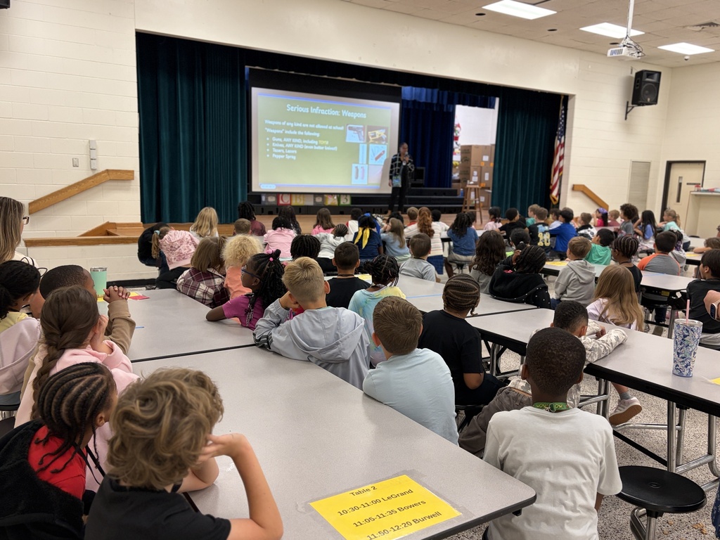 Group of students listening to behavior assembly