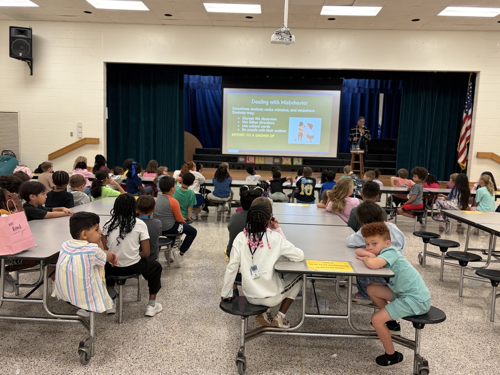 Group of students listening to behavior assembly