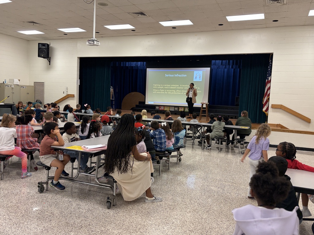 Group of students listening to behavior assembly