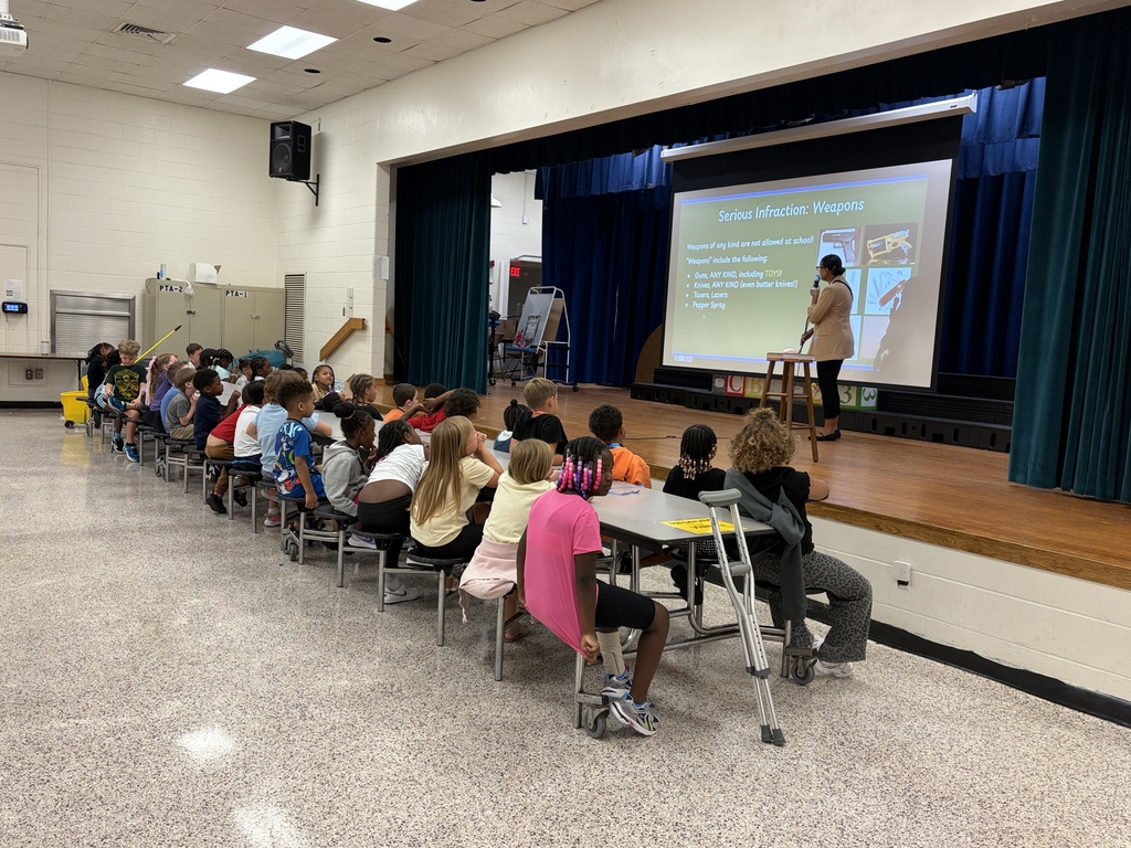 Group of students listening to behavior assembly