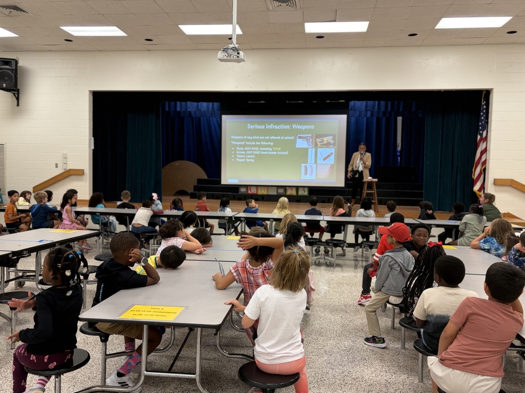 Group of students listening to behavior assembly