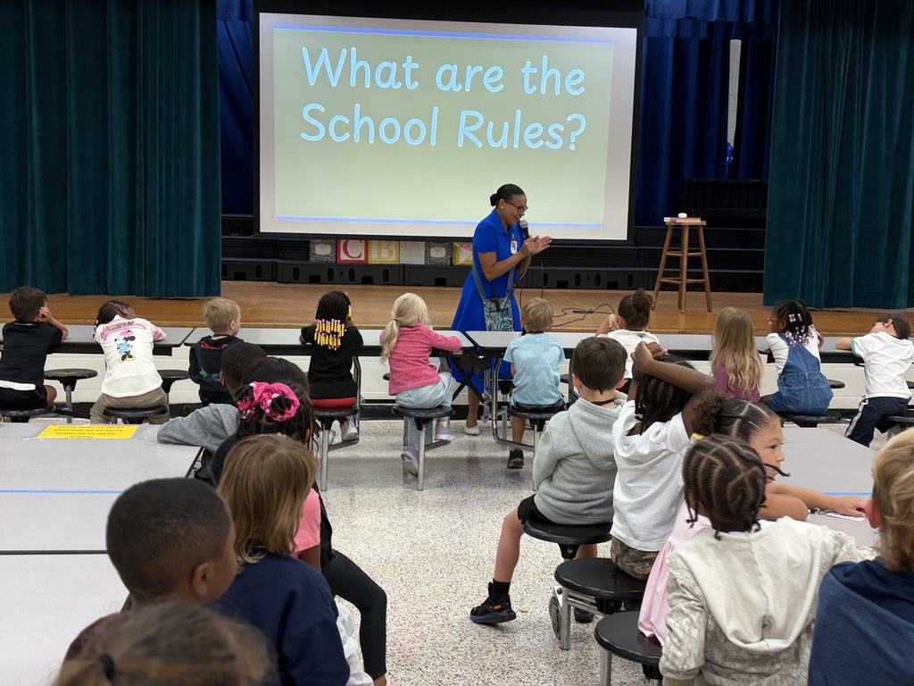 Group of students listening to behavior assembly