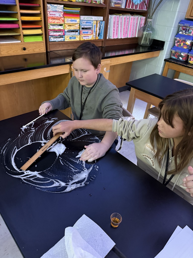student measuring the bubble remains on the desk